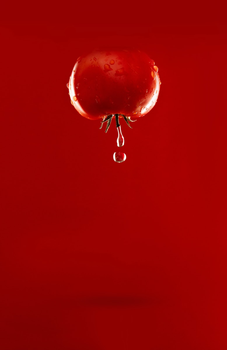 red tomato with water dew